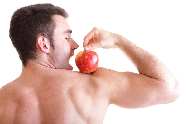 Sportovní sexy mužské tělo tvůrce drží červené jablko — Stock fotografie