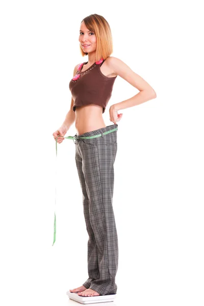 Pretty woman shows her weight loss wearing measure tapes isolate — Stock Photo, Image