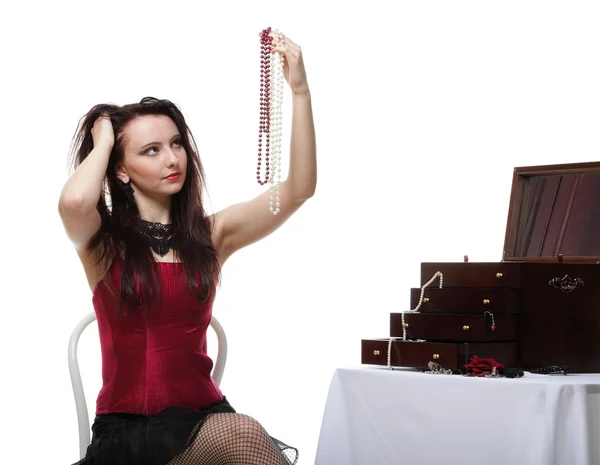 Showgirl woman dance in red corset chair white isolated — Stock Photo, Image