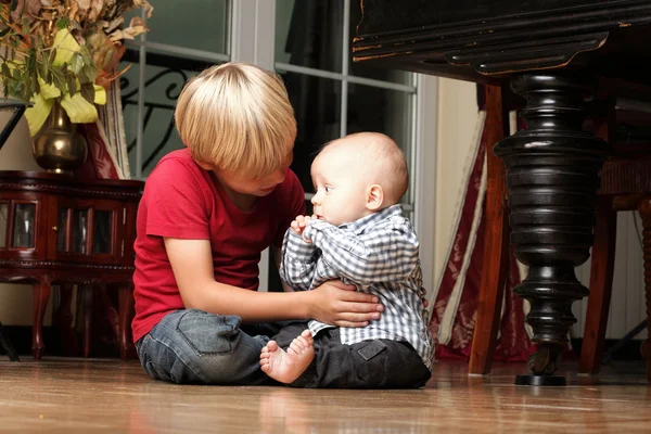 Little boy playing with a brother — Stock Photo, Image