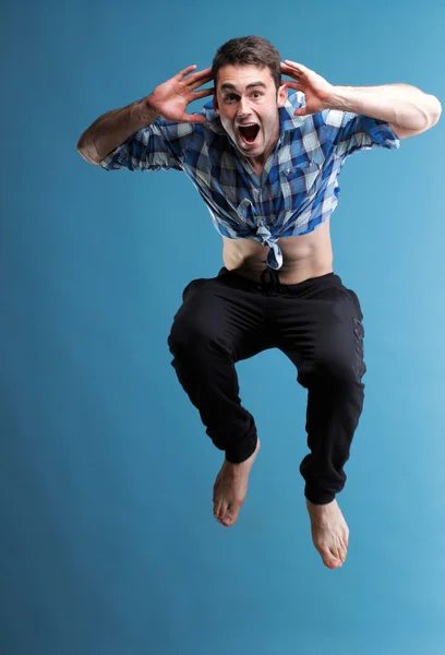 Young man jumping isolated gray background — Stock Photo, Image