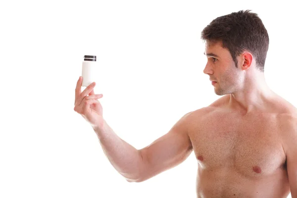 Houden een dozen met supplementen op zijn biceps — Stockfoto