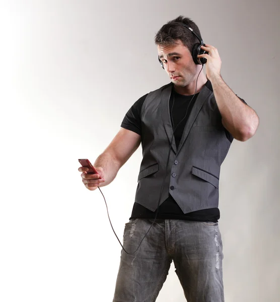 Full length portrait headphone music school boy phone isolated — Stock Photo, Image