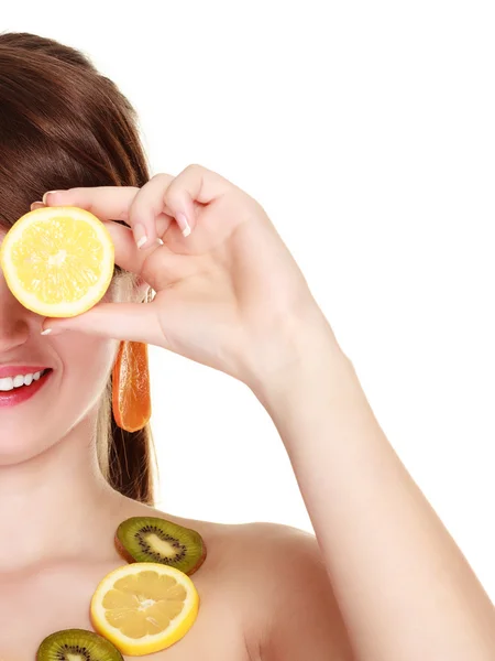 Girl in fruit necklace covering eyes with lemon — Stock Photo, Image