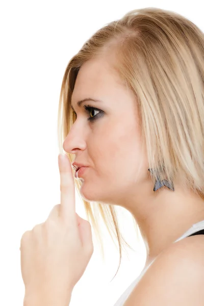 Blonde girl with finger on lips asking for silence — Stock Photo, Image