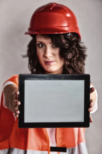 Sexy girl in safety helmet showing tablet