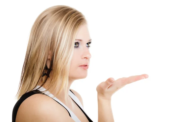 Blonde girl blowing a kiss or with copy space on hand — Stock Photo, Image