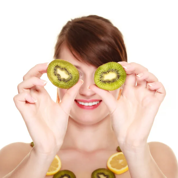 Girl in fruit necklace covering eyes with kiwi — Stock Photo, Image