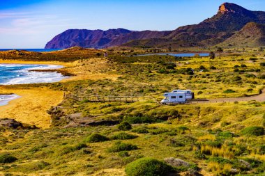 Sahilde kamp yapan karavanlı deniz manzaralı bir karavan. İspanya Murcia bölgesi, Calblanque Bölgesel Parkı.