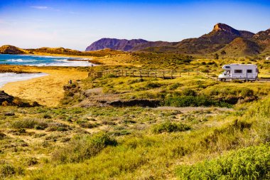 Sahilde kamp yapan karavanlı deniz manzaralı bir karavan. İspanya Murcia bölgesi, Calblanque Bölgesel Parkı.