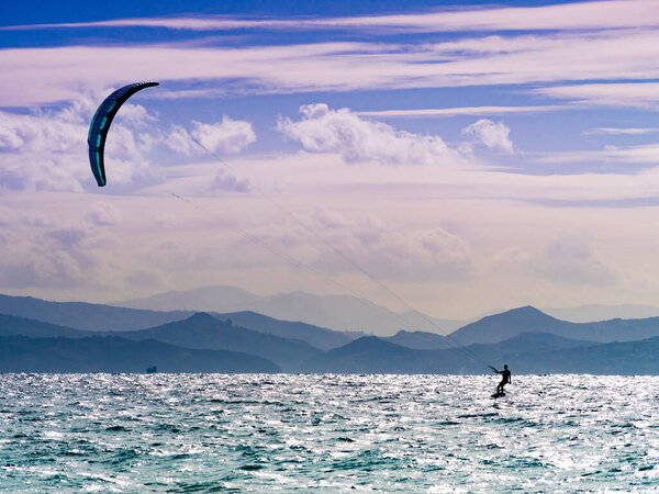 Kiteboarding. Kite surfer rides waves, Tarifa, Cadiz in Spain. Sports activity. Kitesurfing action.