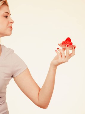 Diet, sweets, food concept. Cute blonde attractive woman about to eat delicious sweet strawberry cupcake