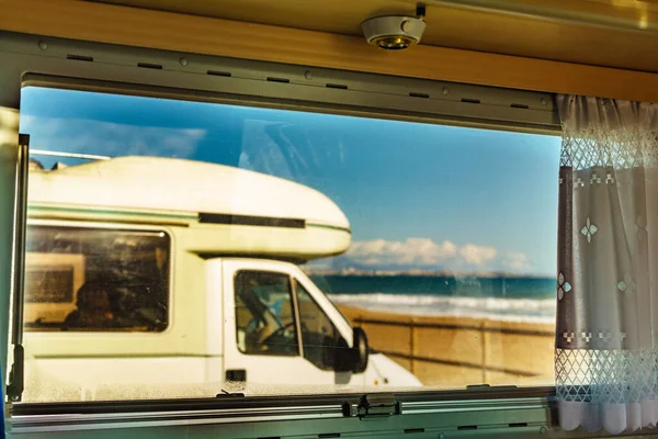 透过大篷车的窗户可以看到在海滩上露营的野营者 驾驶汽车回家冒险 — 图库照片