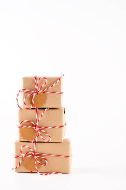 El işi kağıdında hediye kutuları, yaratıcı ve sıfır atık hediye paketi, sürdürülebilir Noel. Beyaz arka planda bir Noel ağacı gibi kutular.