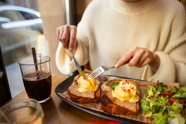 eating breakfast with eggs in a cafe