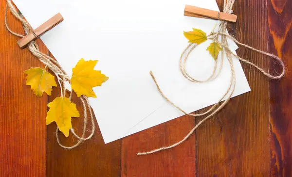 Yellow autumn leaves with paper for text. — Stock Photo, Image