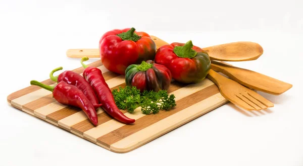 Mixture of different varieties of peppers on the board — Stock Photo, Image