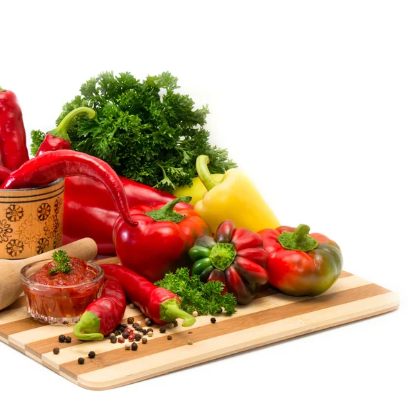 Mixture of different varieties of peppers and sauce — Stock Photo, Image