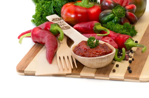 Hot pepper sauce on a wooden spoon — Stock Photo, Image