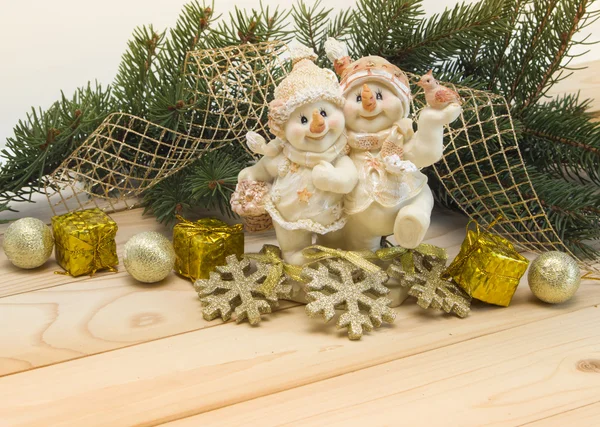 Holiday background with snowmens, pine branches and toys. — Stock Photo, Image