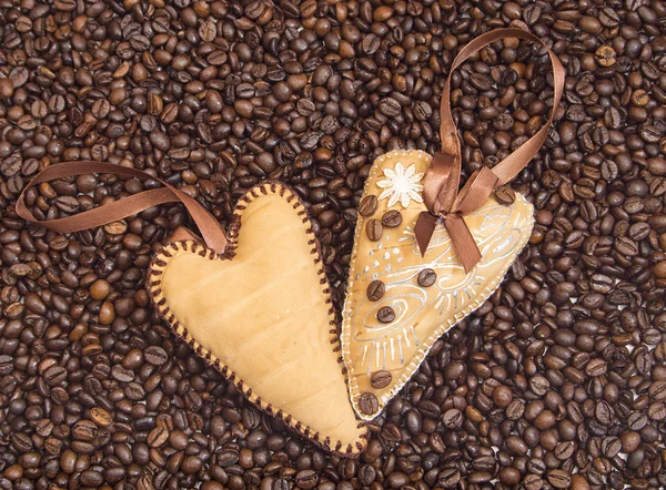 Hearts decorated with coffee beans with ribbons — Stock Photo, Image