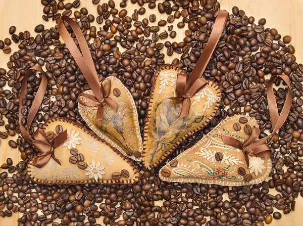 Four decorated hearts with ribbons and coffee beans. — Stock Photo, Image