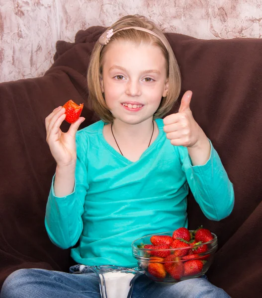 Маленькая девочка ест клубнику — стоковое фото
