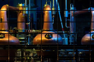 Copper stills for the production of irish Whiskey seen from the public aquare in Ardara, County Donegal - Ireland clipart