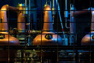 Copper stills for the production of irish Whiskey seen from the public aquare in Ardara, County Donegal - Ireland clipart