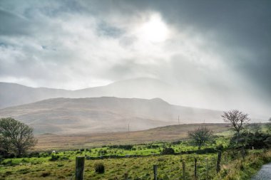 Rain coming in at the Bluestack Mountains between Glenties and Ballybofey in County Donegal - Ireland clipart