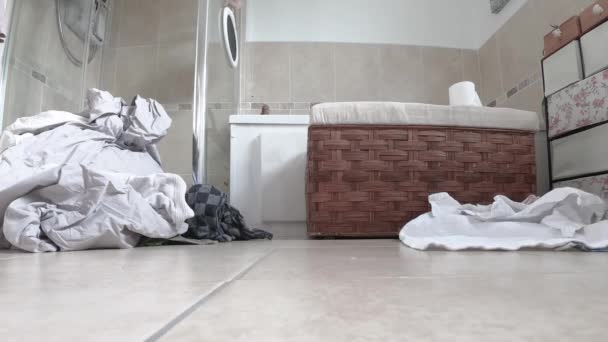 Time lapse of laundry piling up in the bathroom — Stock Video
