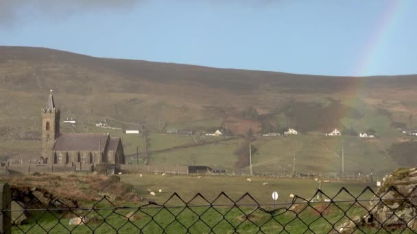 Fence with St. Colomas Church of Ireland in the background, Glencolumbkille - Republic of Ireland — стоковое видео