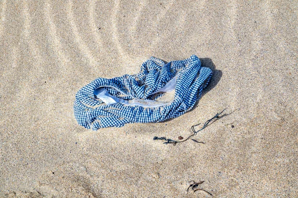 Lost swim trousers lying on the sandy beach — Stock Photo, Image