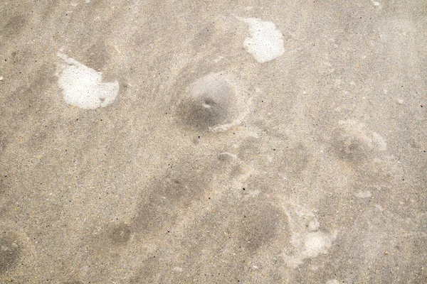 Bulles dans le sable montrant que la marée arrive — Photo