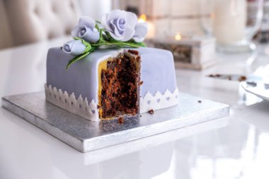 Mavi güllerle süslenmiş güzel meyveli pasta.