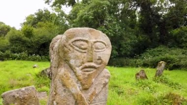 This is a bronze age stone carviing with two faces,called Janus, located In Caldragh Cemetery on Boa Island, Lower Lough Erne. Northern Ireland.