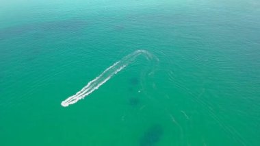 Aerial of jet ski driving on the Atlantic Ocean in Dwoning, County Donegal - Ireland.