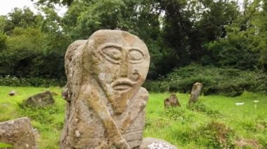 This is a bronze age stone carviing with two faces,called Janus, located In Caldragh Cemetery on Boa Island, Lower Lough Erne. Northern Ireland.