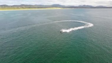 Aerial of jet ski driving on the Atlantic Ocean in Downings, County Donegal - Ireland.