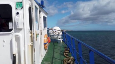 MAGHERAROARTY, COUNTY DONEGAL, IRELAND - AUGUST 25 2022 : The ferry is driving through rough sea between Magheraroarty and Tory Island.