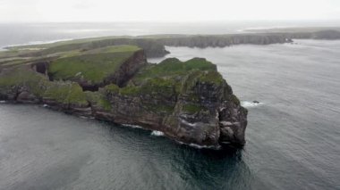 The cliffs and sea stacks An Tor Mor and the Wishing Stone at Port Challa on Tory Island, County Donegal, Ireland.