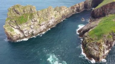 The cliffs and sea stacks An Tor Mor and the Wishing Stone at Port Challa on Tory Island, County Donegal, Ireland.
