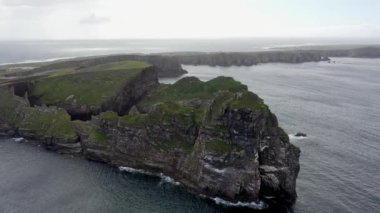 The cliffs and sea stacks An Tor Mor and the Wishing Stone at Port Challa on Tory Island, County Donegal, Ireland.