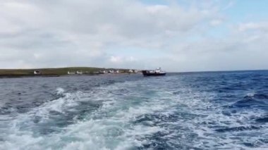 MAGHERAROARTY, COUNTY DONEGAL, IRELAND - AUGUST 25 2022 : The ferry is driving through rough sea between Magheraroarty and Tory Island.