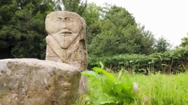 This is a bronze age stone carviing with two faces,called Janus, located In Caldragh Cemetery on Boa Island, Lower Lough Erne. Northern Ireland.