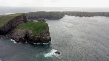 The cliffs and sea stacks An Tor Mor and the Wishing Stone at Port Challa on Tory Island, County Donegal, Ireland.