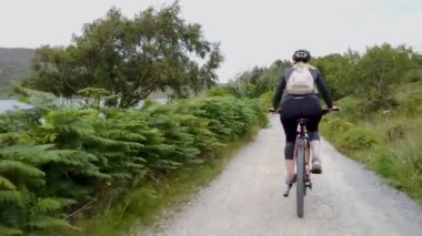 Beautiful lady cycling her mountain bike in County Donegal, Ireland.