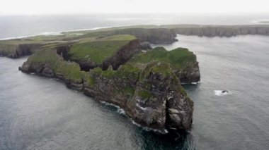The cliffs and sea stacks An Tor Mor and the Wishing Stone at Port Challa on Tory Island, County Donegal, Ireland.