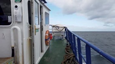 MAGHERAROARTY, COUNTY DONEGAL, IRELAND - AUGUST 25 2022 : The ferry is driving through rough sea between Magheraroarty and Tory Island.