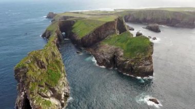 The cliffs and sea stacks An Tor Mor and the Wishing Stone at Port Challa on Tory Island, County Donegal, Ireland.
